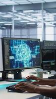 Vertical Machine learning expert in AI server room developing disaster recovery plans ensuring minimal downtime. Employee monitoring performance in artificial intelligence ran data center, camera A video