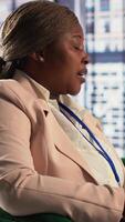 Vertical Diverse entrepreneurs in a strategic briefing meeting discussing corporate growth and leadership goals. Group of business associates in office driving productivity and collaboration. Camera A. video