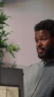 Vertical African american analyst discussing about monthly revenue with shareholders, attending videoconference call remote meeting. Entrepreneur asking for more funds, online communication. Camera A. video