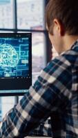 Developer writing code on computer and doing maintenance on artificial intelligence neural networks computerized model. Tech support expert typing on keyboard, doing checkup on AI systems, camera B video