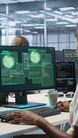 Vertical Team of engineers in server hub trying to protect gear from hacker stealing sensitive information. Data center coworkers struggling to erase virus after seeing security breach notification, camera A video