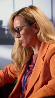 Vertical Woman CEO feeling disappointed with a business failure and bad news, unhappy frustrated director being overworked and trying to develop the enterprise. Sad displeased leader, downfall. Camera A. video