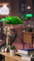 Vertical Refined vintage library with wooden shelves and classic green lamps, a calm workspace for booklovers. Empty study area perfect for learning, reading or enjoying the charm of a scholarly setting. video