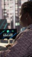 Vertical Executive assistant in high end office works on infographics data analysis for problem solving tasks, planning resource allocation to support business growth and accomplish goals. Camera B. video