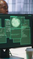 Vertical Software developers in server hub trying to protect gear from hacker stealing data. Data center colleagues struggling to erase virus after seeing system hacked notification, camera A video