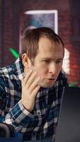 Manager calls employee remotely using internet videocall to offer negative feedback on project progress. Angry team leader berating teleworker at home in teleconference meeting, camera B video