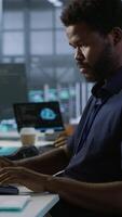 Vertical AI system administrator in server room listening music, developing disaster recovery plans ensuring minimal downtime. Neural networks specialist in data center monitoring performance, camera A video