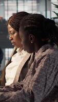 Vertical Black business staff strategizing a plan for growth in modern office, focusing on company goals by developing a sustainable enterprise strategy to achieve corporate success and objectives. Camera A. video
