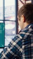 Man in home office using generative artificial intelligence website generating videos using diffusion models. Person wearing headphones using AI virtual assistant producing clips for him, camera B