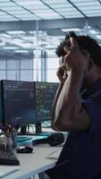 Vertical AI system administrator in server room listening music, developing disaster recovery plans ensuring minimal downtime. Neural networks specialist in data center monitoring performance, camera A video