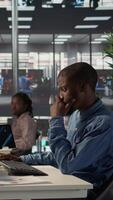 Vertical Male enterprise worker conducting financial planning and goal setting, demonstrating expertise in budget management. Expert analyzing online reports and forecasts to drive growth plans. Camera B. video