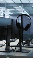Vertical Artificial intelligence applications used in data center workplace to maintain company network equipment, handheld camera shot. AI programs used in server room to ensure optimal system performance video
