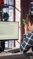Software developer at computer waiting for code to finish compiling, yawning, feeling bored. Impatient man tired to wait for algorithms building scripts to finish, camera A video