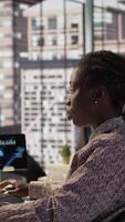 Vertical African american staff analyzing financial data for strategic planning, debating resource allocation for effective business operations. Analyst does financial forecasting and analysis. Camera B. video