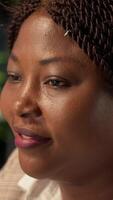 Vertical Black executive analyst finalizes financial report and reviews data, developing a forecast for organizational progress. Woman engaged in task management and strategy planning. Close up. Camera A. video