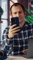 Happy employee at home office desk organizes calendar appointments, doing videocall with coworkers. Worker preparing for corporate event, doing remote videoconference meeting with colleagues, camera B video