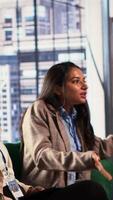 Vertical Frustrated businesswomen starting an argument and expressing their irritation, dealing with an enterprise failure and negative outcome. Stressed angry associates fighting in a meeting. Camera A. video