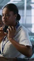 Vertical Coworker giving server hub engineer insights into developing disaster recovery plans ensuring minimal downtime. Worker helping colleague in data center monitoring performance, camera A video