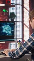 Teleworking programmer using computer for artificial intelligence computing through self learning algorithms. Remote worker working with AI deep neural networks on desktop PC, camera A video