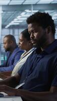 Vertical Developers in data center workspace implementing AI predictive maintenance systems. Admin in server hub office using artificial intelligence machine learning tech to identify hardware failures video