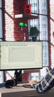 Man in home office looking at UI on PC screen, typing and executing programming code. Coding application UI used by IT developer writing and testing code in modern workspace, camera A video