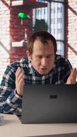 Manager calls employee remotely using internet videocall to offer negative feedback on project progress. Angry team leader berating teleworker at home in teleconference meeting, camera A video