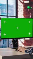 Teleworking man in living room home office using chroma key computer to plan business development. Remote worker doing project research, typing on green screen device keyboard, camera A video
