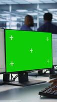 Vertical Software developer in server farm ensuring data remains shielded from potential threats using mockup PC. IT expert safeguarding data center against hackers with green screen computer, camera A video