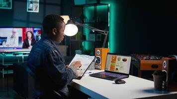 Self employed woman working in personal office, checking statistical data financial graphs on laptop screen. Remote employee in living room comparing business graphic economic figures, camera B video