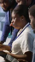 Vertical Team of data center technicians maintaining company network infrastructure by configuring and troubleshooting hardware. Teamworking server hub colleagues ensuring optimal system performance, camera A video
