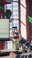 Man in home office looking at social media feed with live broadcasts from online content creators. Employee at work using social network application with livestreams done by influencers, camera A video