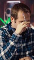 Stressed man in home office scratching head with pen, upset after having to answer too many emails on laptop. Fatigued teleworker feeling overworked by too many project tasks, camera B video
