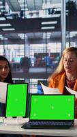 Vertical Team of female shareholders meeting to discuss expansion plan next to isolated mockup, sharing their ideas to use more funds on a development project. Working for success and productivity. Camera B. video