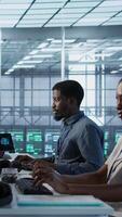 Vertical Admin arriving in server room, starting work on developing disaster recovery plans ensuring minimal downtime. Employee entering data center, beginning job shift, monitoring performance, camera A video