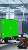 Vertical Data center technician using mockup PC, maintaining company network infrastructure. Server hub worker ensuring optimal system performance with green screen computer, camera A video