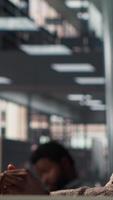 Vertical African american staff analyzing financial data for strategic planning, debating resource allocation for effective business operations. Analyst does financial forecasting and analysis. Camera A. video