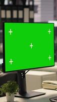 Vertical Businesswoman at office desk looks at green screen on device, studying documents and infographics to support effective decision making and company objectives. Administrative tasks. Camera A. video