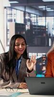 Vertical Diverse general managers collaborate in office analyzing data for expansion plan, women in business. CEOs discussing strategies for leadership development and achieving greatness together. Camera A. video