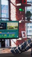 editor analyzing film montage on computer screen before editing color grading and lighting in creative home office. Post production studio employee working with raw footage on PC, camera A video
