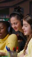 Vertical Young students and tutor attending an online class via call in the library, focused on distance learning and completing a school assignment with other classmates on the network. Camera B. video