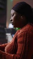 Vertical Confident tutor reading her notes and preparing teaching materials at a library desk, showcasing her dedication to pedagogy and mentoring. Establishing private lessons for academic support. Camera B. video
