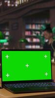 Vertical Diverse schoolgirls taking notes and completing theoretical exercises in a library with copy space, showcasing positive academic development and a productive homework session. Camera A. video