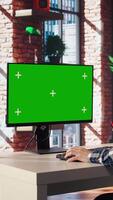 Teleworker in living room home office using chroma key PC to answer emails from business associates. Remote employee typing on isolated screen device keyboard, solving tasks in apartment, camera A video
