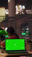 Vertical Diverse people working on their assignments in a library with green screen, finishing homework after classes. Schoolgirls discuss with tutors about literature, productive study sessions. Camera A. video
