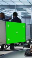 Vertical Technician using isolated screen computer, working in server farm to optimize it for data processing requirements. IT professional coding on chroma key PC in data center, camera A video
