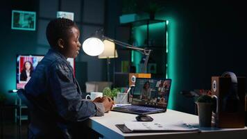 Remote worker talks with board of directors during videocall business meeting from home office. Teleworker speaks in remote videoconference telework call, receiving feedback from management, camera B video