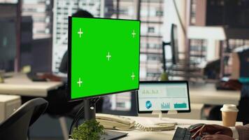 Woman at her desk working on data analysis next to mockup display, engaged in business tasks and budget management to drive effective corporate strategy. Analyst reads reports numbers. Camera A. video