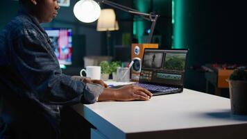 editor selecting key frames to use while doing montage, using specialized software applications. Freelancer using editing tools on computer to cut movie project footage in office, camera B video