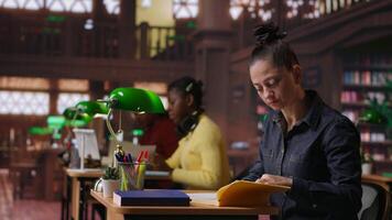 Teacher preparing class notes and learning materials for a teaching session in an academic environment. Intelligent professor tutoring with academic resources at the study area. Camera B. video