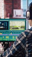 editor analyzing film montage, editing color grading and lighting in creative home office, zoom in. Post production studio employee working with raw footage to improve quality, camera A close up video